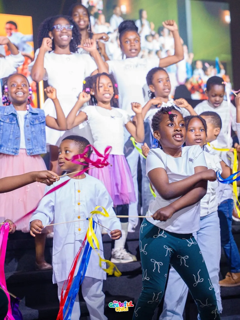Children of King's Seeds dancing with coloured ribbons on stage at Kingdom Stars Assembly in Guelph