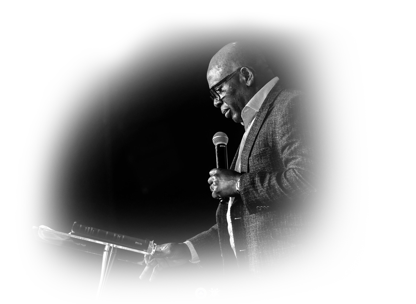 Pastor David Adeosun preaching with a microphone at Kingdom Stars Assembly in Guelph